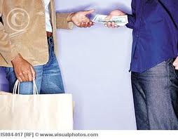 man handing cash to woman